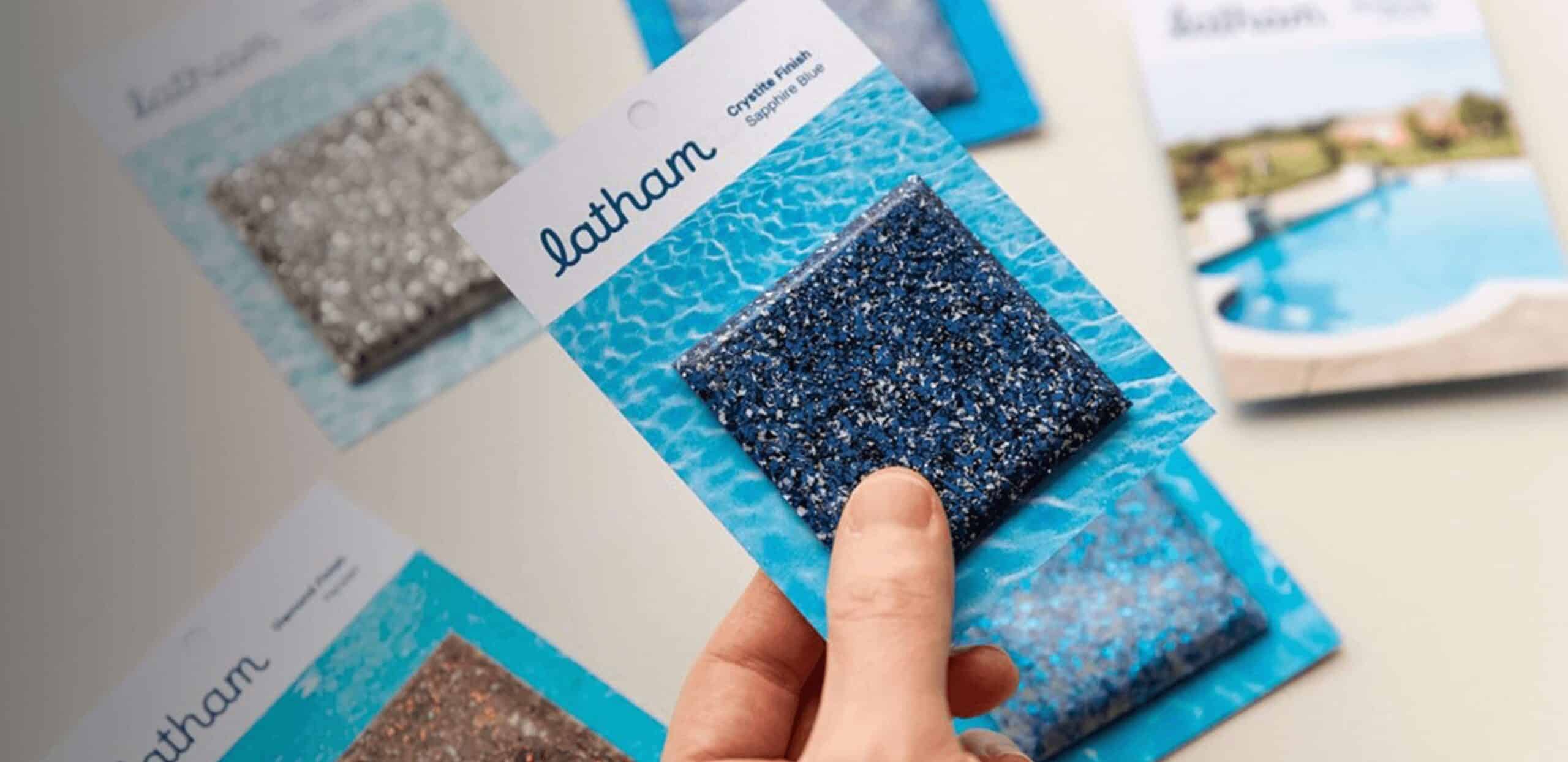 Hand holding Latham fiberglass pool finish color samples