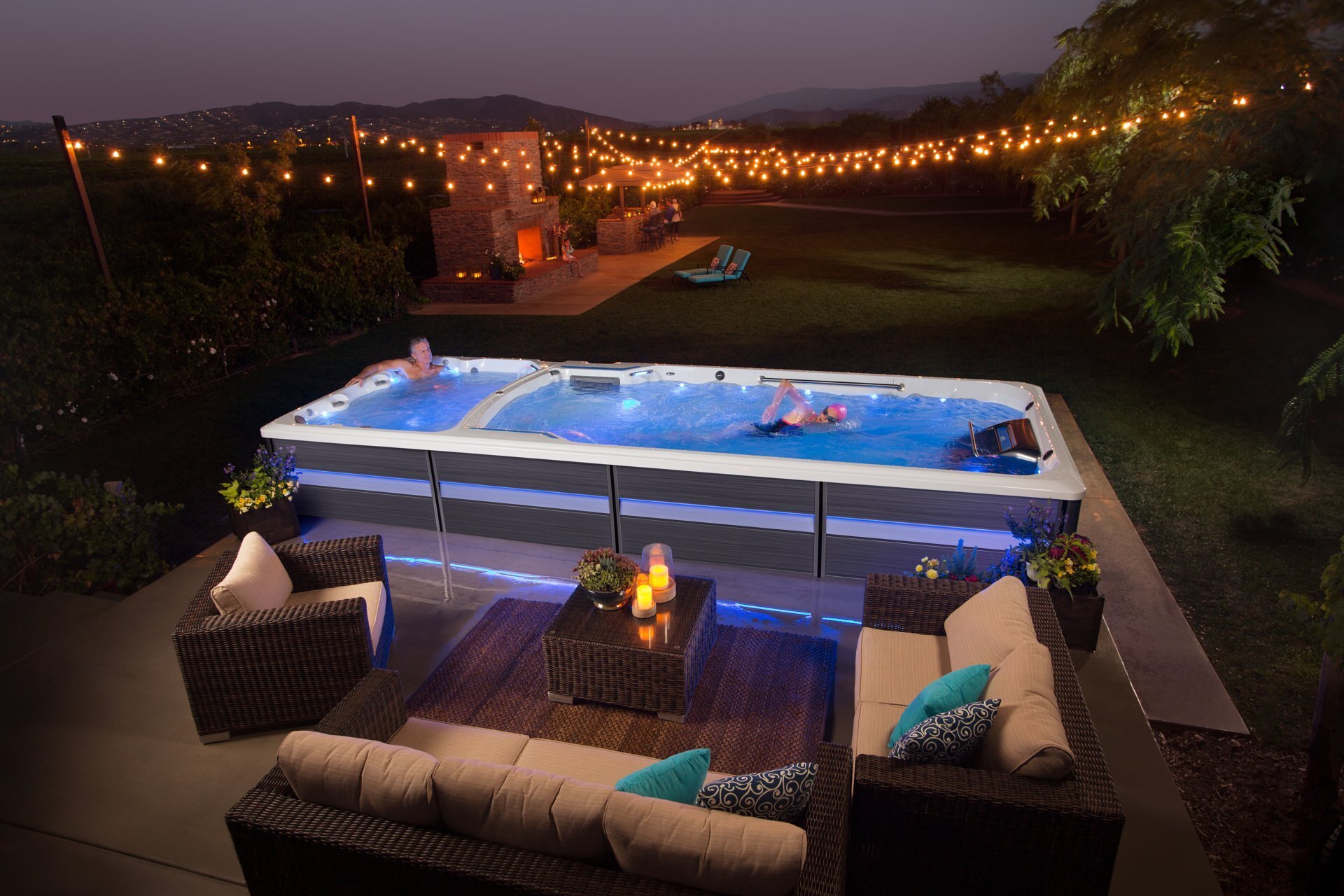 Swimming in an Endless Pools swim spa lit up at dusk
