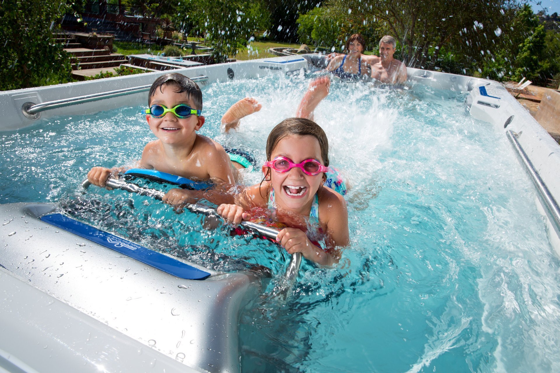 Children swimming and playing while adults relax in an Endless Pools swim spa