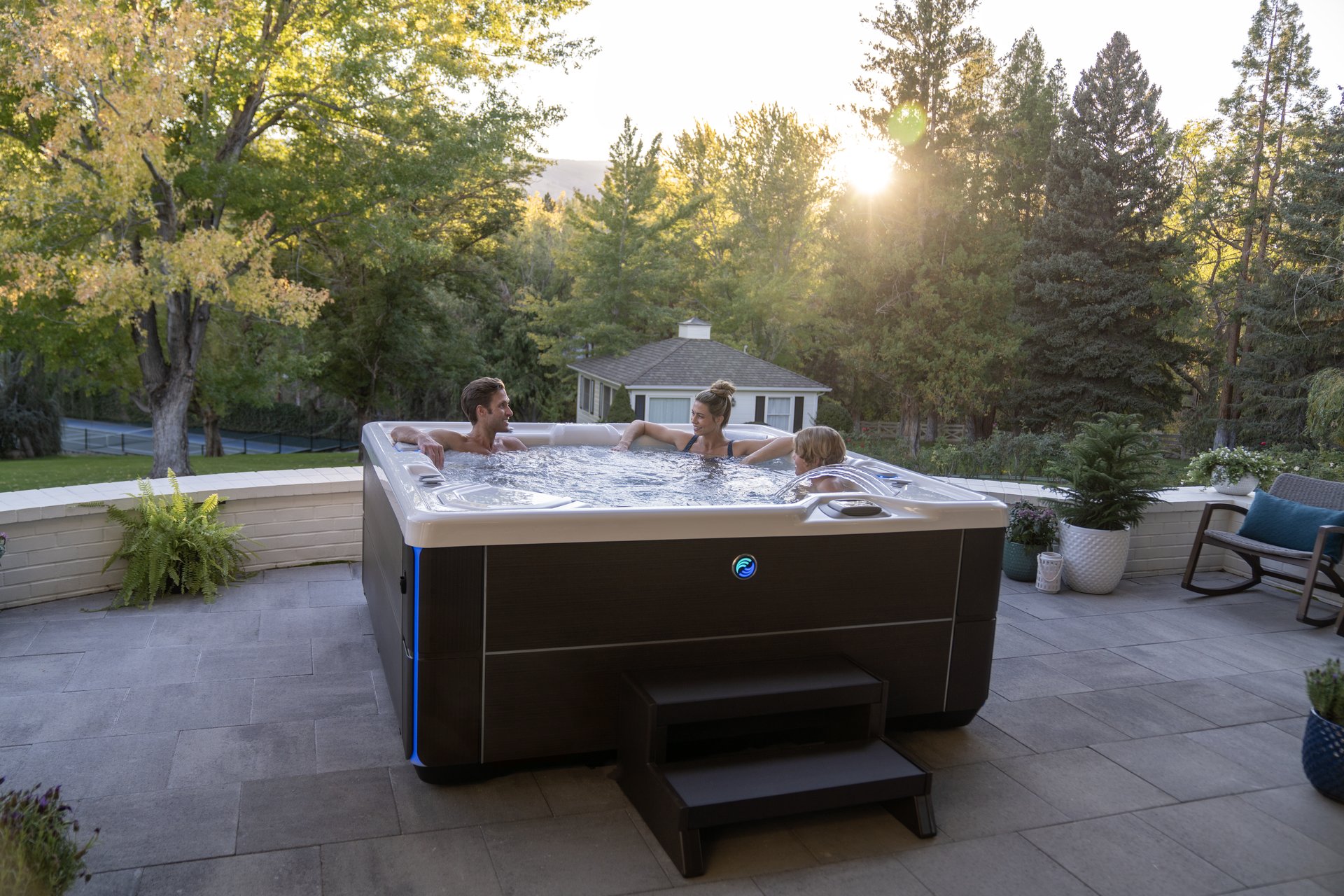 Family relaxing together in a Hot Spring Highlife Vanguard spa