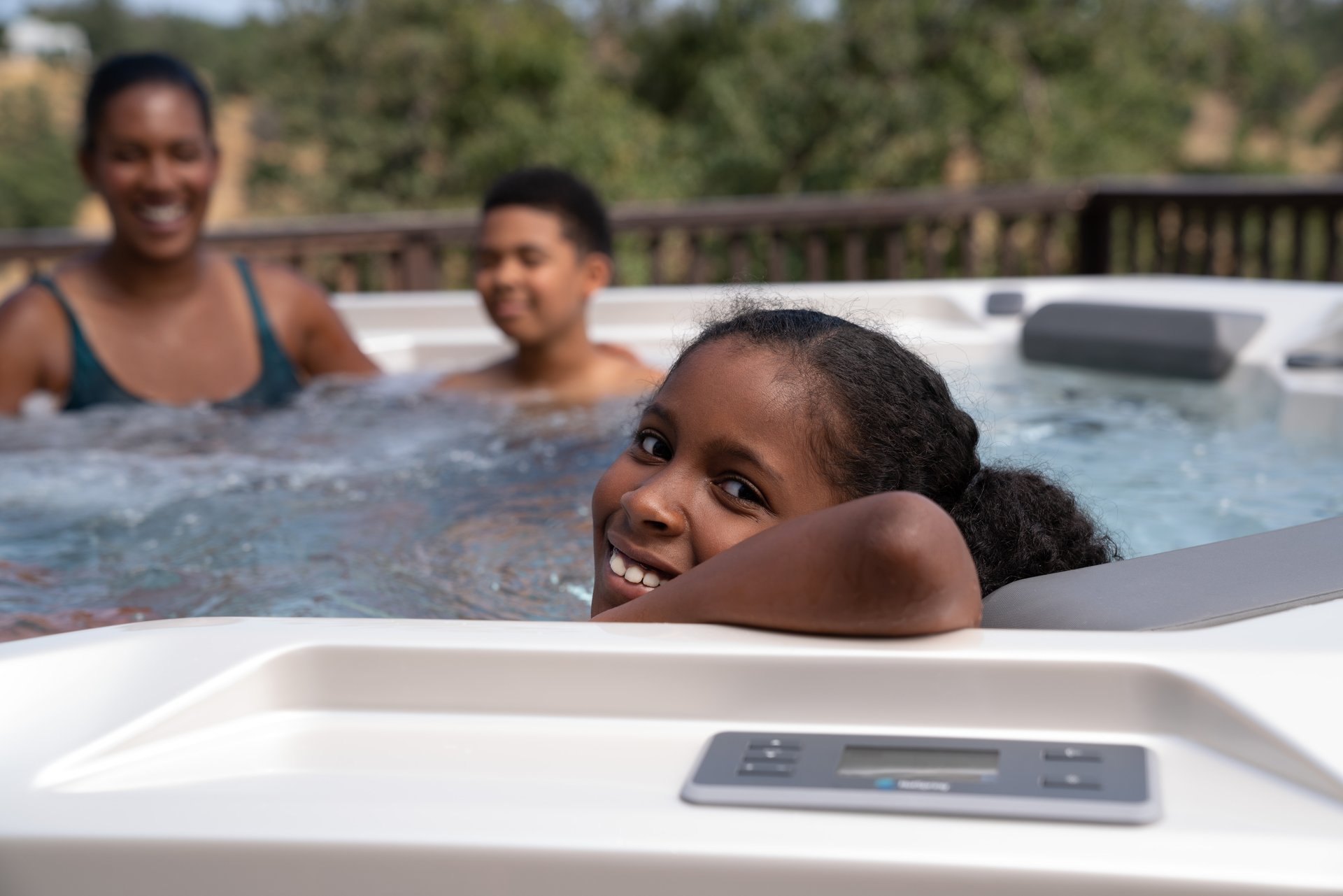 A family relaxing in a Hot Spring Hot Spot Rhythm spa