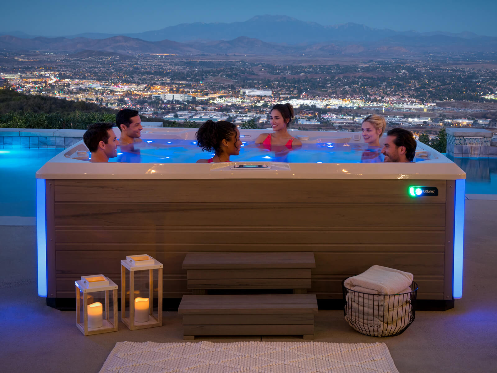Hot Spring Limelight Prism spa lit at night with two people relaxing