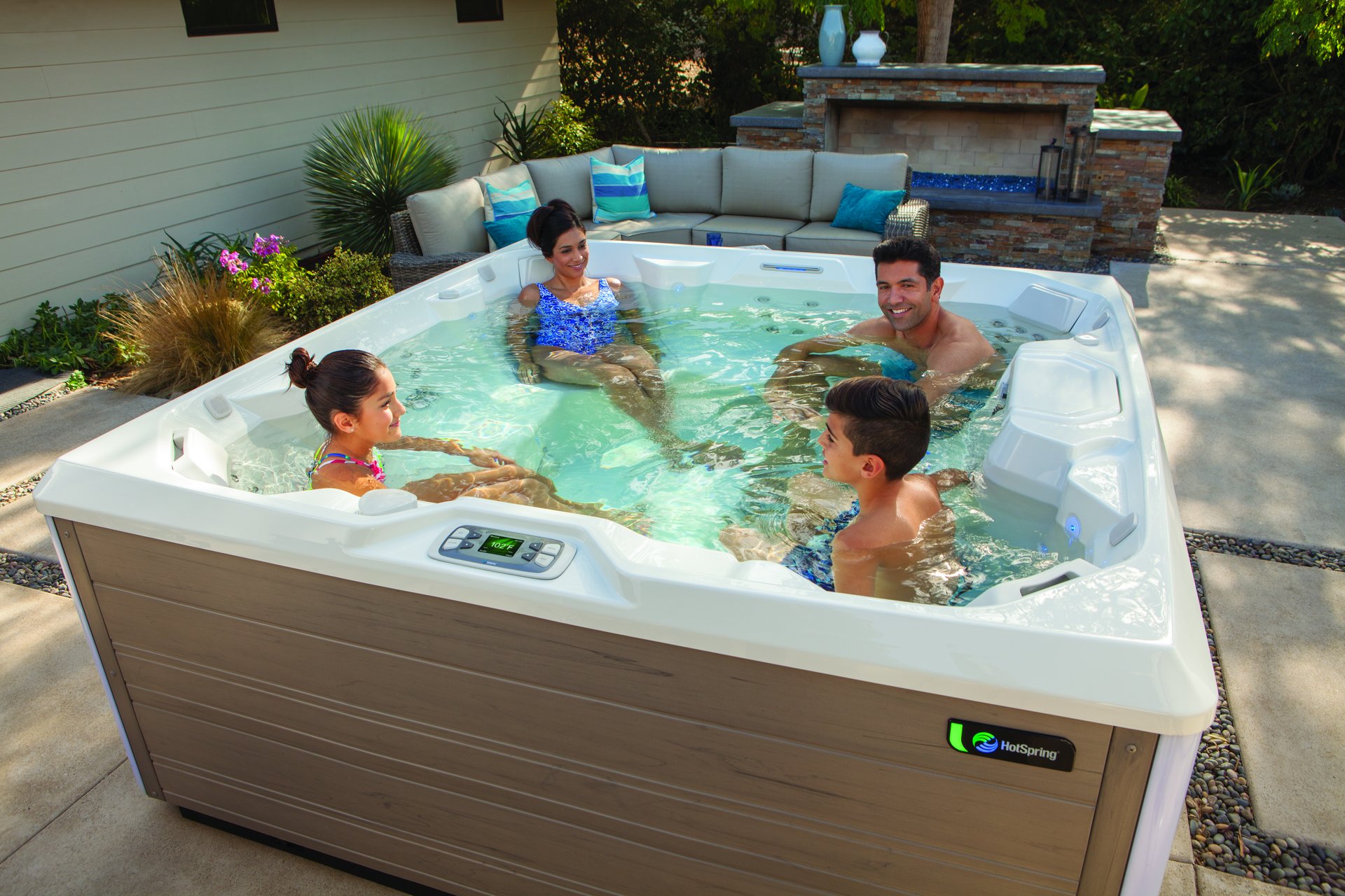 Family enjoying a Hot Spring Limelight Pulse spa together