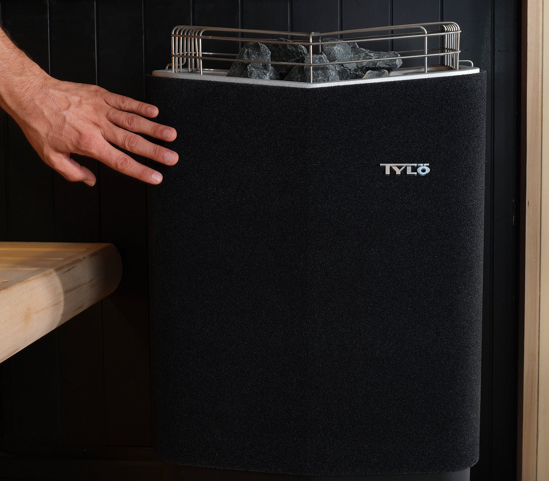 Hand held near the cool ThermoSafe side panel of a Tylo heater